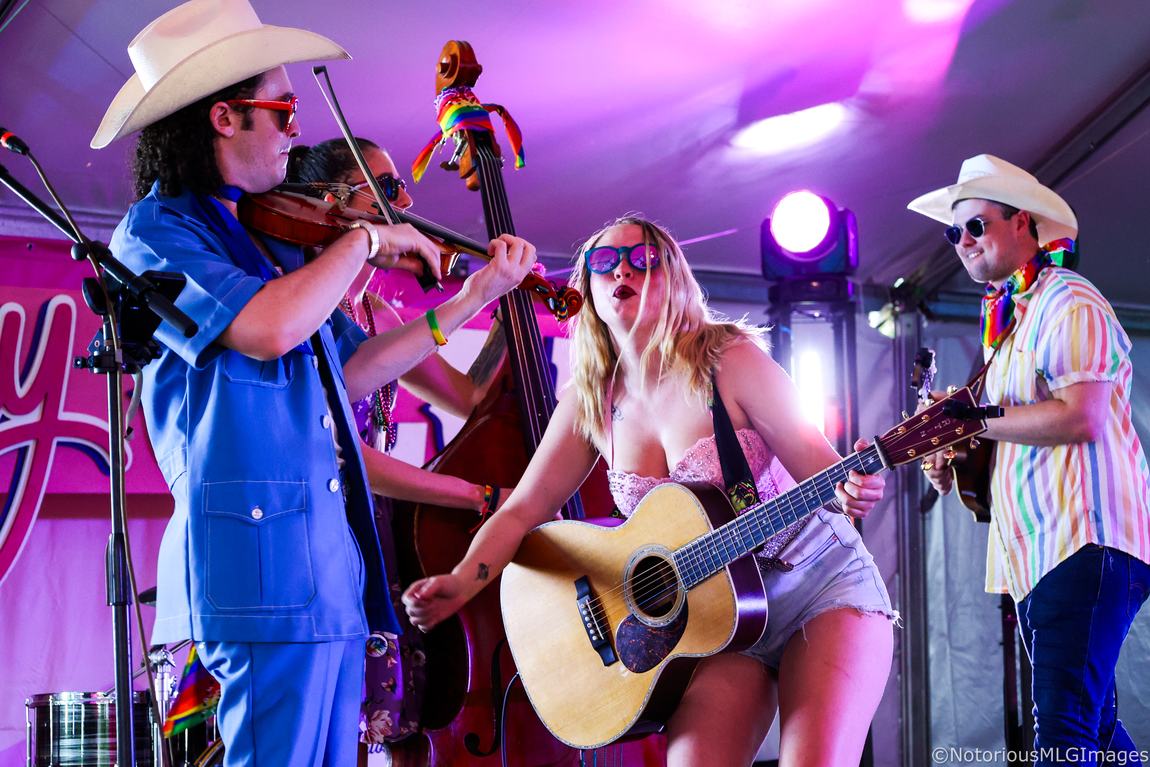 Ariel Jade on stage with fiddle, upright bass and mandolin